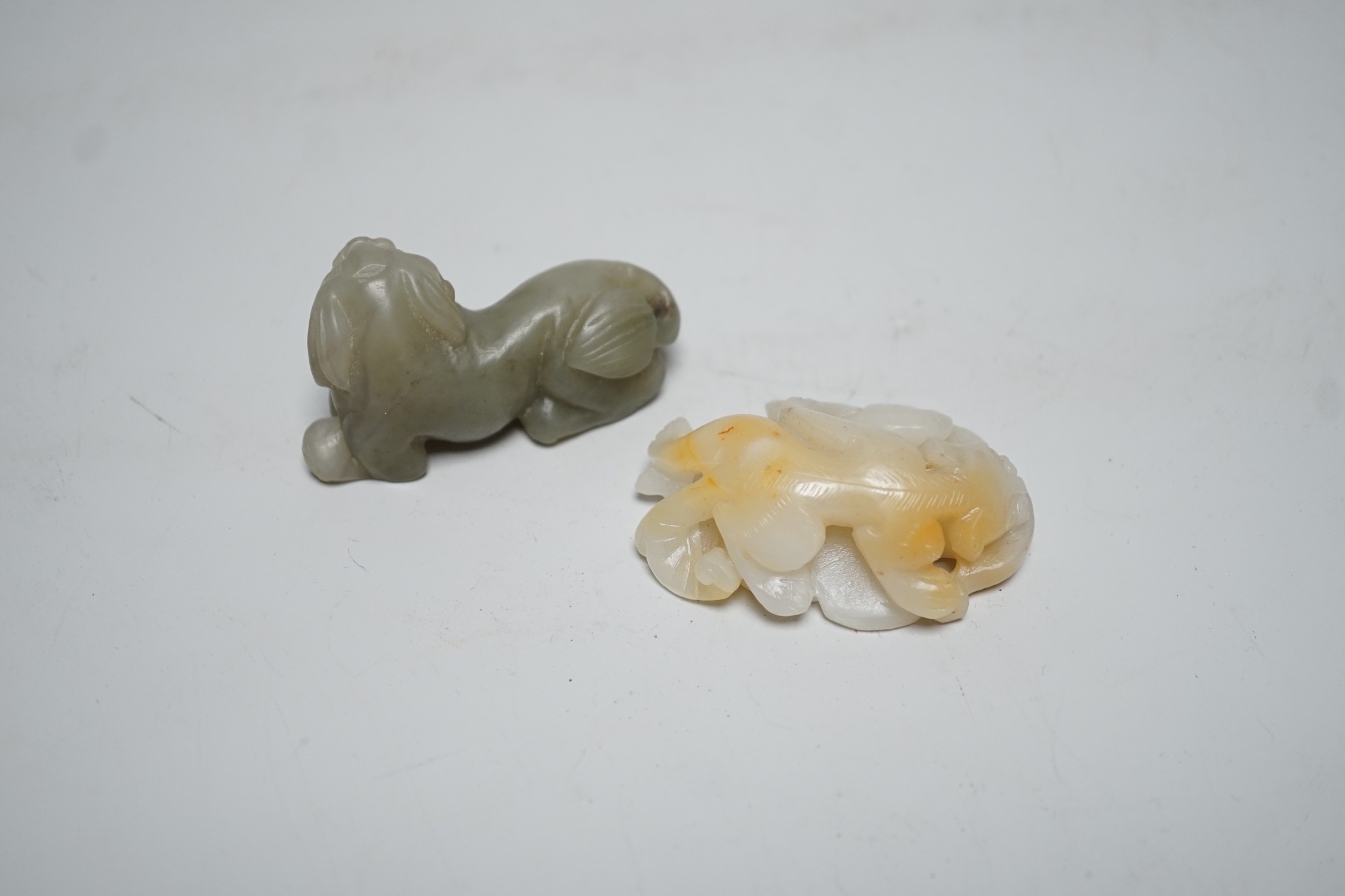 A Chinese white and russet Jade chilong carving and a celadon jade figure of a lion-dog, 7cm